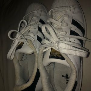 white and black stripped superstar adidas